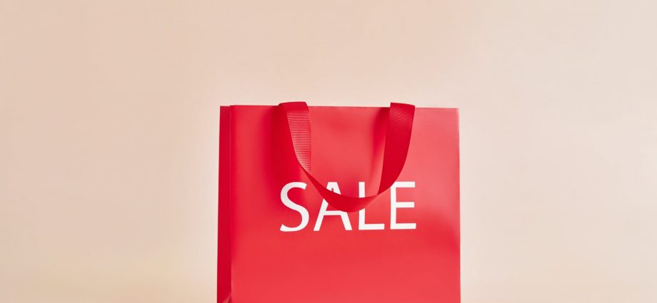 red paper bag with sale sign